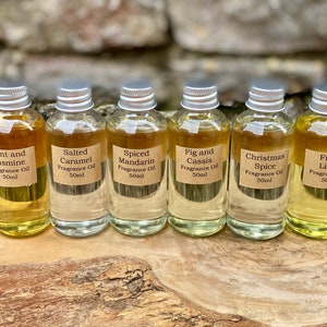 May include: Six small glass bottles of fragrance oil with silver caps and brown labels. The labels read: Mint and Jasmine, Salted Caramel, Spiced Mandarin, Fig and Cassis, Christmas Spice, and Fresh Linen. Each bottle contains 50ml of oil.