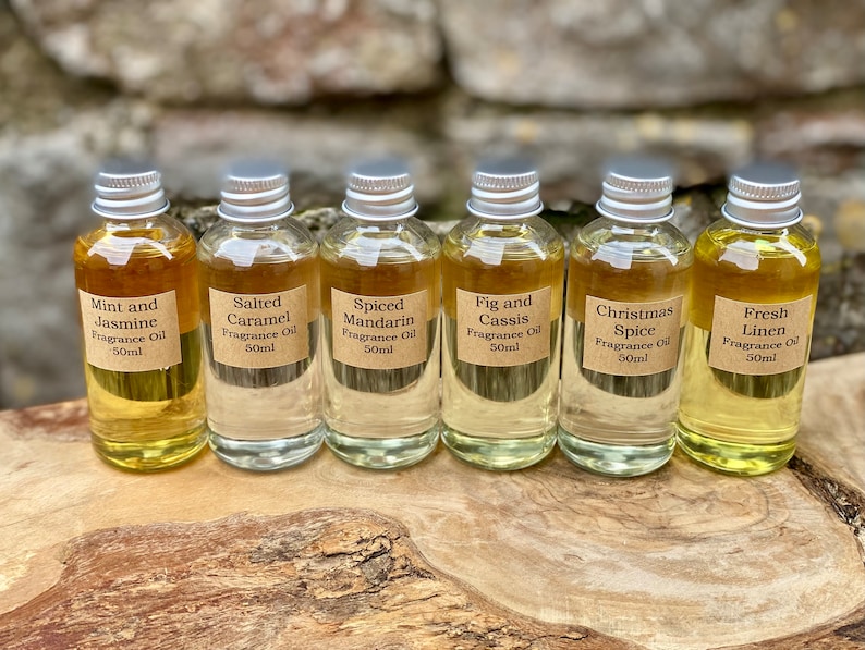 May include: Six small glass bottles of fragrance oil with silver caps and brown labels. The labels read: Mint and Jasmine, Salted Caramel, Spiced Mandarin, Fig and Cassis, Christmas Spice, and Fresh Linen. Each bottle contains 50ml of oil.