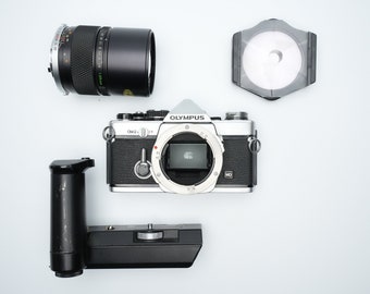 Olympus OM-2N with 135mm 2.8 lens - equipped with many extras