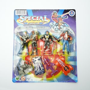 May include: A Special Force action figure set on a blue and yellow blister pack. The set includes several action figures and miniature vehicles. The packaging features the text "Special Force" and illustrations of action figures.
