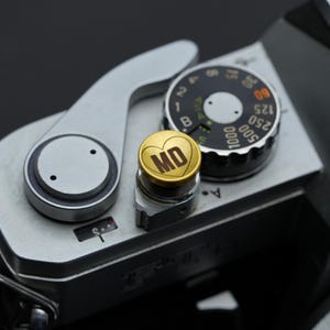 Laser engraved shutter button for your camera