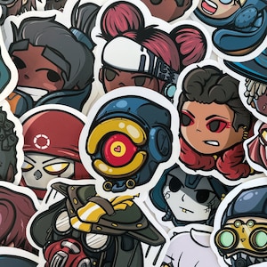 May include: A collection of colourful cartoon character stickers featuring characters from the video game Apex Legends. The stickers feature characters like Bloodhound, Lifeline, Octane, and Mirage.