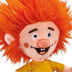 May include: A plush toy with orange hair, a pink nose, and a yellow shirt. The toy has a big smile and white eyes.