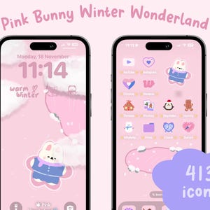 May include: A pink and white phone screen with a winter wonderland theme. The screen shows a pink bunny wearing a blue jacket and a white hat. The time is 11:14 and the date is Monday, 18 November. The screen also shows a variety of app icons, including Instagram, YouTube, and Clock. The text "warm winter" is displayed on the screen. The phone screen is surrounded by a white border.