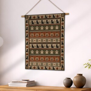 Halloween wall tapestry with black cats, pumpkins, and ghosts in a repeating pattern.