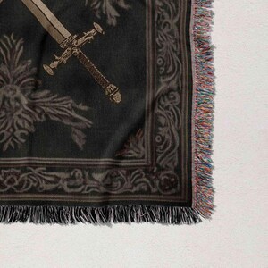 a close-up view of a decorative fabric with a sword design on it.