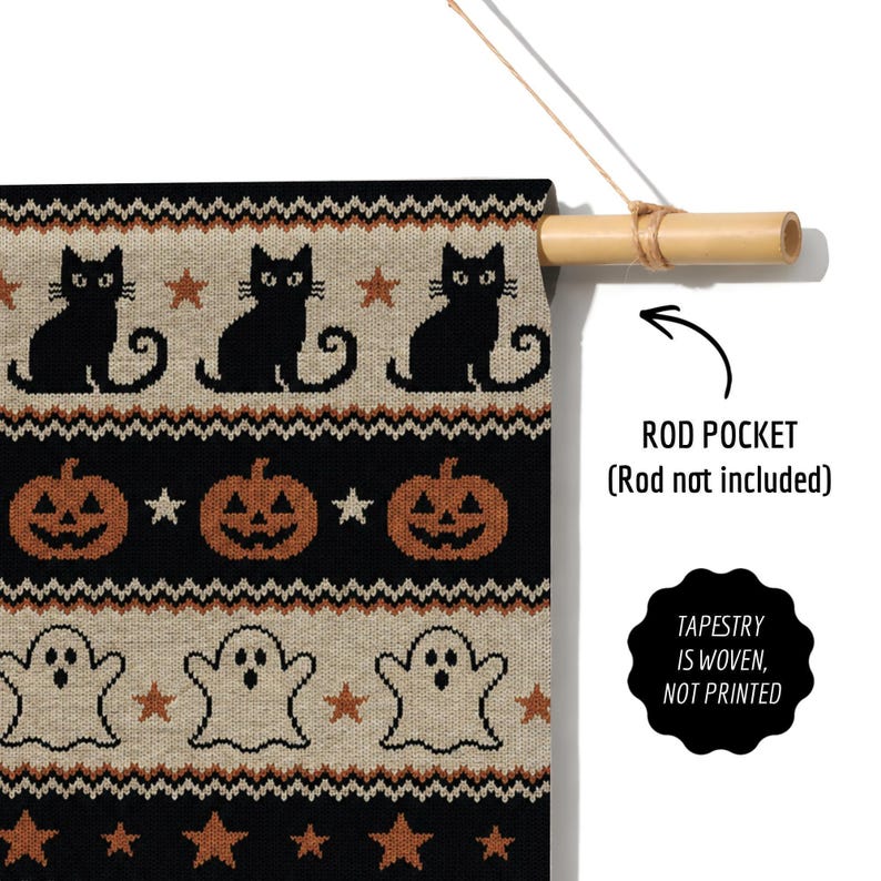 Knitted Halloween tapestry with black cats, pumpkins, and ghosts, held by a bamboo rod.