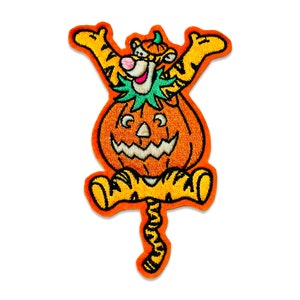 May include: Orange embroidered iron-on patch of a cartoon tiger dressed as a jack-o'-lantern. The tiger is wearing a green hat and has a friendly face.