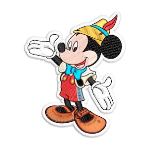 May include: An embroidered patch featuring Mickey Mouse dressed as a jester. He is wearing a yellow and brown hat with a feather, a red and white costume, and blue and white shoes.