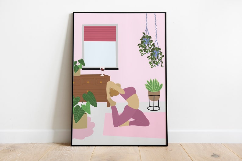 May include: A framed art print depicts a yoga scene in a pink room. A person is in the king pigeon pose on a pink mat. The room includes a window with a red blind, a wooden dresser, and hanging plants. A glass of wine sits on the dresser.