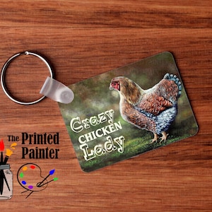 May include: A colorful key chain with a brown and white chicken on a green background. The text "Crazy Chicken Lady" is printed on the key chain.