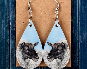 Blue & White Sheep Dangle Earrings With A Gold Tone Finish Blue & White Sheep Dangle Earrings With A Gold Tone Finish