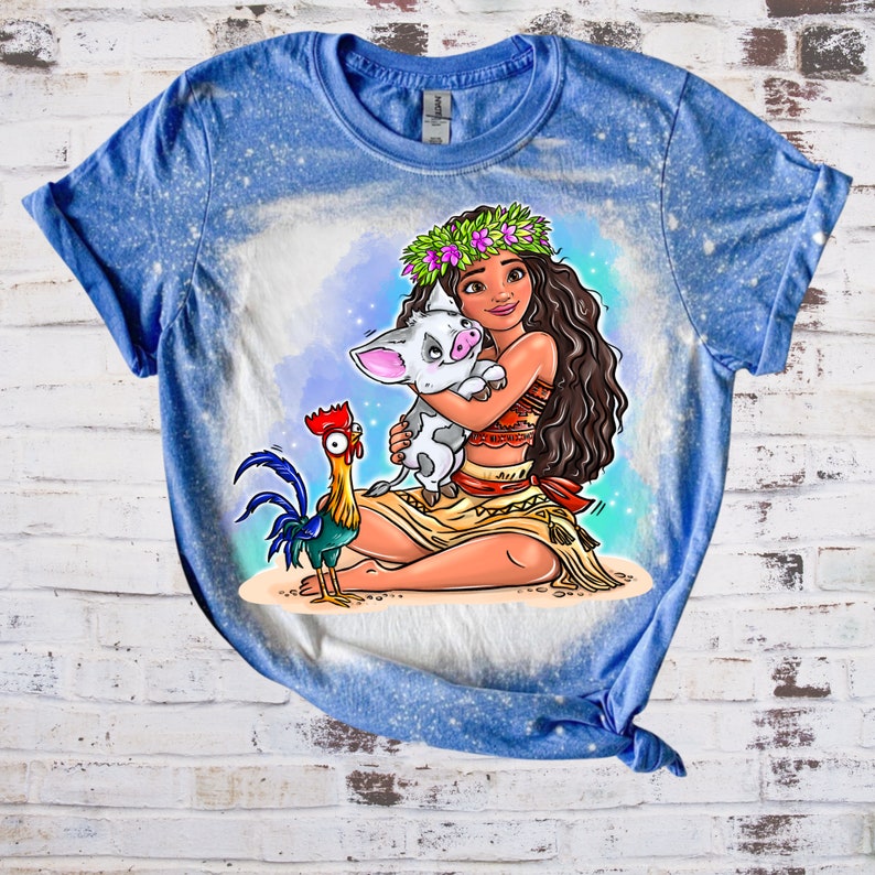 May include: A blue t-shirt with a bleach-splattered design featuring a cartoon image of Moana from Disney's Moana, holding a pig, with a rooster in the foreground.