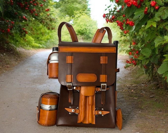 Handmade  leather bushcraft bag  a bushcraft axe,  handmade folding pan, aluminum water carrier,  camping pot, bushcraft drill, and bowsaw