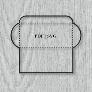 May include: Black outline of an envelope design with rounded corners and the text "PDF | SVG" in the center. The design is on a light gray wood grain background. Dotted lines indicate folding areas.
