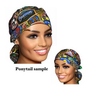 May include: A colorful surgical scrub hat with a ponytail opening. The hat is covered in patches with national park logos, including "Oregon Crater Lake".