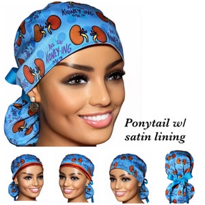 May include: Blue surgical scrub hat with a red and white kidney print and the text "Are you kidney-ing me?" The hat has a satin lining and a ponytail opening.