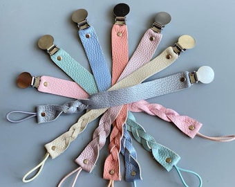 May include: Assortment of ten braided leather dummy clips in various pastel colours, including pink, blue, green, and beige. Each clip features a silver metal clasp and a gold metal button.