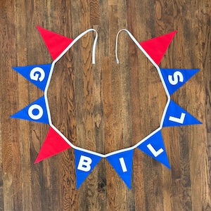 May include: A festive banner with alternating red and blue pennants. The blue pennants display the words "GO BILLS" in white capital letters. The banner is strung on a white ribbon and is suitable for sports-themed parties.