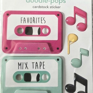 May include: A set of two pink and green cassette tape stickers with the words "FAVORITES" and "MIX TAPE" on them. The stickers are surrounded by four music note stickers in pink, yellow, green, and black.
