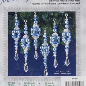 May include: A package of a beaded crystal Christmas ornament kit. The kit includes six blue and white ornaments with crystal accents. The package reads "Nostalgic Christmas" and includes the text "4.5 in. (11 cm)".