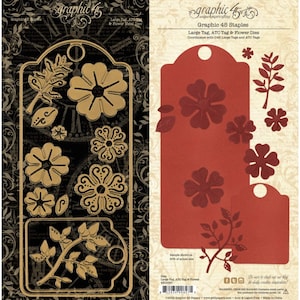 May include: A set of metal cutting dies labeled Graphic 45 Staples Large Tag, ATC Tag & Flower Dies. The set includes shapes for a large tag, a smaller tag, various five-petaled flowers, and leafy branches, displayed on black and cream backgrounds.