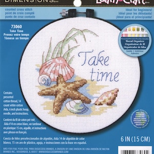 May include: A cross-stitch kit featuring a beach scene with a starfish, seashells, and the words "Take Time." The kit includes pre-sorted cotton thread, a 6-inch plastic hoop, needle, and instructions. Ideal for beginners.