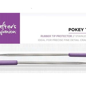 May include: A two-piece set of Crafter's Companion Pokey Tools in retail packaging. Each tool features a sharp stainless steel needle point and a purple rubber tip protector. The white and purple card displays the text 2 PC PZ, POKEY TOOL, RUBBER TIP PROTECTOR, STAINLESS STEEL, and IDEAL FOR PRECISE FINE DETAIL CRAFT WORK.