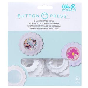 May include: A package of We R Makers Button Press Shaker Shapes Refill. The package features white, scalloped-edge shaker shapes with clear windows. Some shapes contain colorful confetti and a disco ball design. The package has the text "BUTTON PRESS" and "SHAKER SHAPES REFILL".