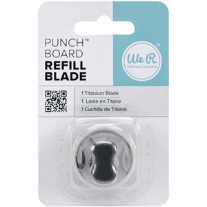 May include: A white and light blue package containing a black punch board refill blade. The package has the text "PUNCH BOARD REFILL BLADE" and "We R memory keepers". The package also includes the text "1 Titanium Blade".