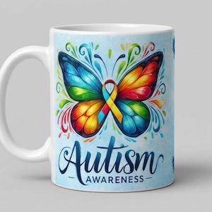 May include: A white ceramic mug featuring a colourful butterfly graphic with a multi-coloured awareness ribbon in the centre. The text below the butterfly reads Autism Awareness in a dark blue script font against a light blue background.