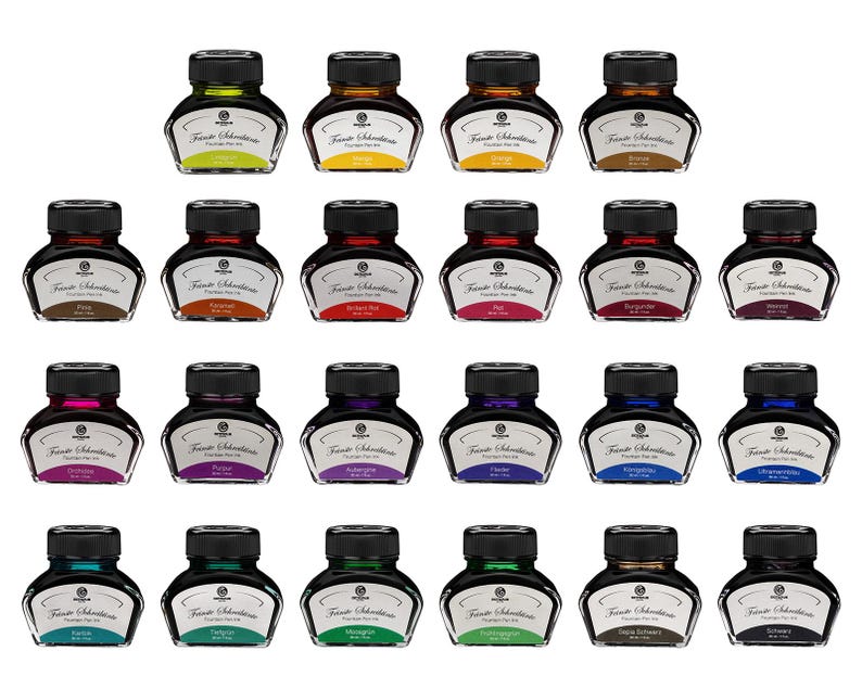 May include: A collection of twenty-one bottles of fountain pen ink in various colors. Each bottle has a black cap and a label with the brand name. The ink colors include green, yellow, brown, red, purple, blue, and teal.