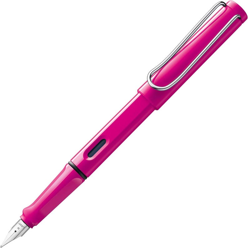 May include: A pink fountain pen with a silver clip and a black ink cartridge. The pen has a fine nib.