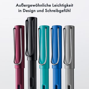 May include: Five fountain pens in different colours: black, burgundy, teal, blue, and grey. Each pen has a clip and a metal nib.