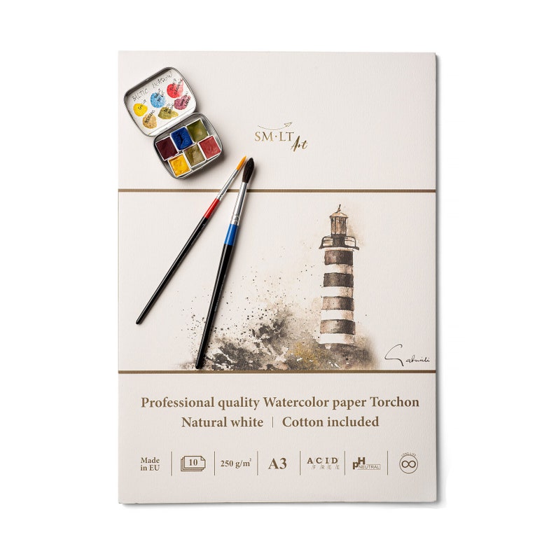 May include: A pack of watercolor paper with a lighthouse illustration, two paintbrushes, and a small tin of watercolor paints. The paper is 250 gsm, acid free, and made in the EU. The pack is A3 size.