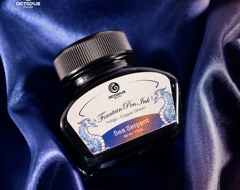 May include: A glass bottle of indigo fountain pen ink with a copper sheen. The bottle is labeled "Octopus Fluids Fountain Pen Ink Indigo Copper Sheen Sea Serpent 30 ml - 1 fl.oz."