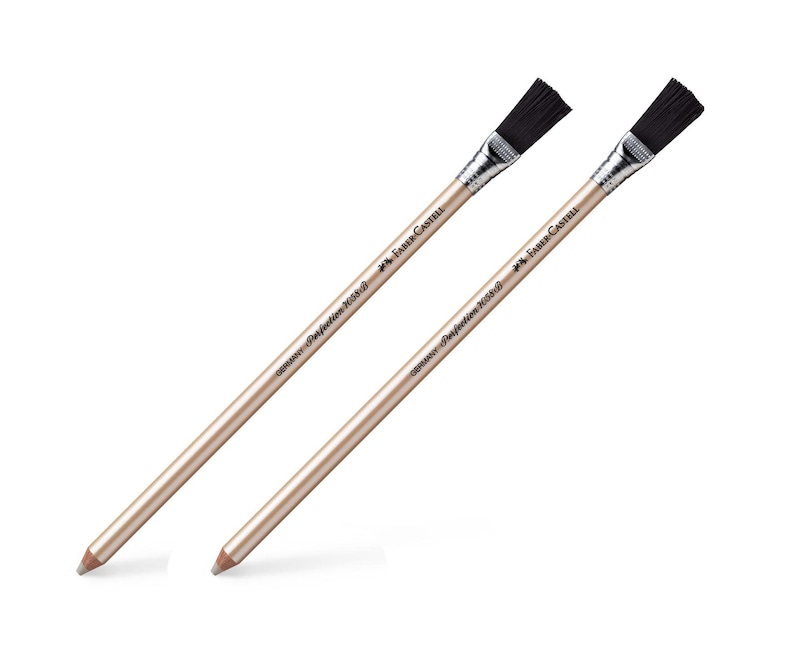 May include: Two Faber-Castell Perfection 7058 pencils with attached black eraser brushes. The pencils have a gold-colored barrel and silver metal ferrule. The text "GERMANY Perfection 7058" and the Faber-Castell logo are printed on the pencils.