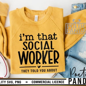 May include: A yellow sweatshirt with black text that reads "i'm that social worker they told you about". The text is in a playful, handwritten font. The sweatshirt is laid out on a white surface with a pair of blue jeans and a white sneaker.