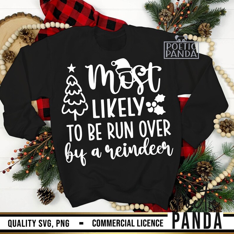 May include: Black sweatshirt with the text "Most Likely To Be Run Over by a Reindeer" in white. The design includes a Christmas tree, Santa hat, and holly. The sweatshirt is surrounded by Christmas decorations.