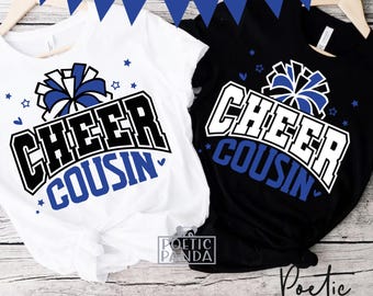 May include: Two white and black t-shirts with blue accents. The shirts feature a cheerleading pom-pom and the text "Cheer Cousin".