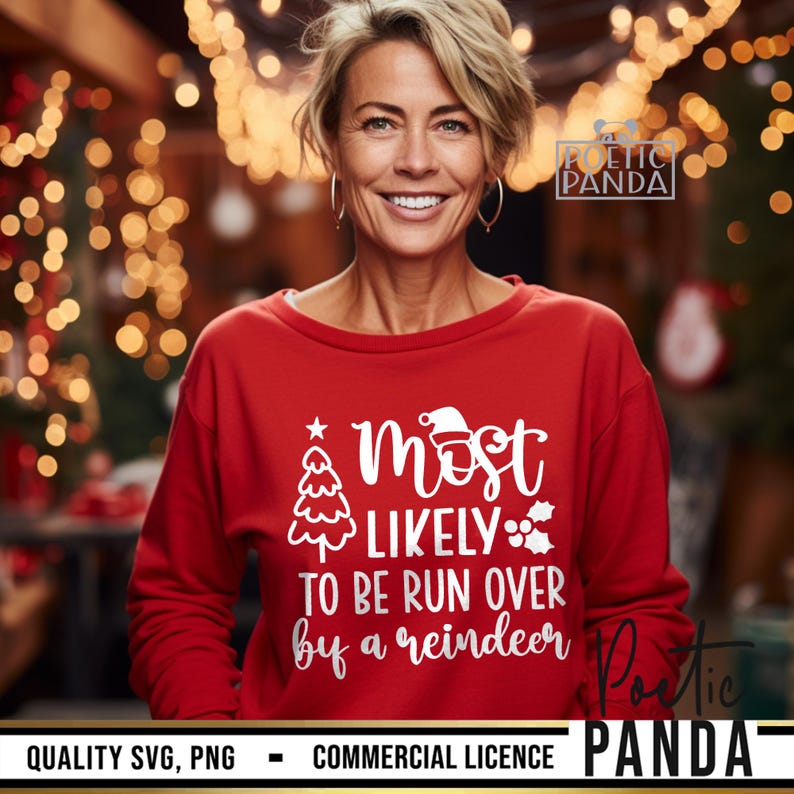 May include: A red sweatshirt with the text "Most Likely To Be Run Over By A Reindeer" in white. The design includes a Christmas tree, Santa hat, and holly. The sweatshirt is worn by a person smiling.