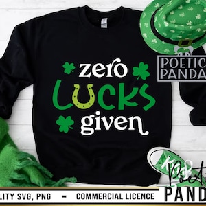 May include: Black sweatshirt with a white graphic that says "*zero* LUCKS *given*" with a green shamrock and horseshoe design. The text "POETIC PANDA" is in a gray box on the right side of the image.