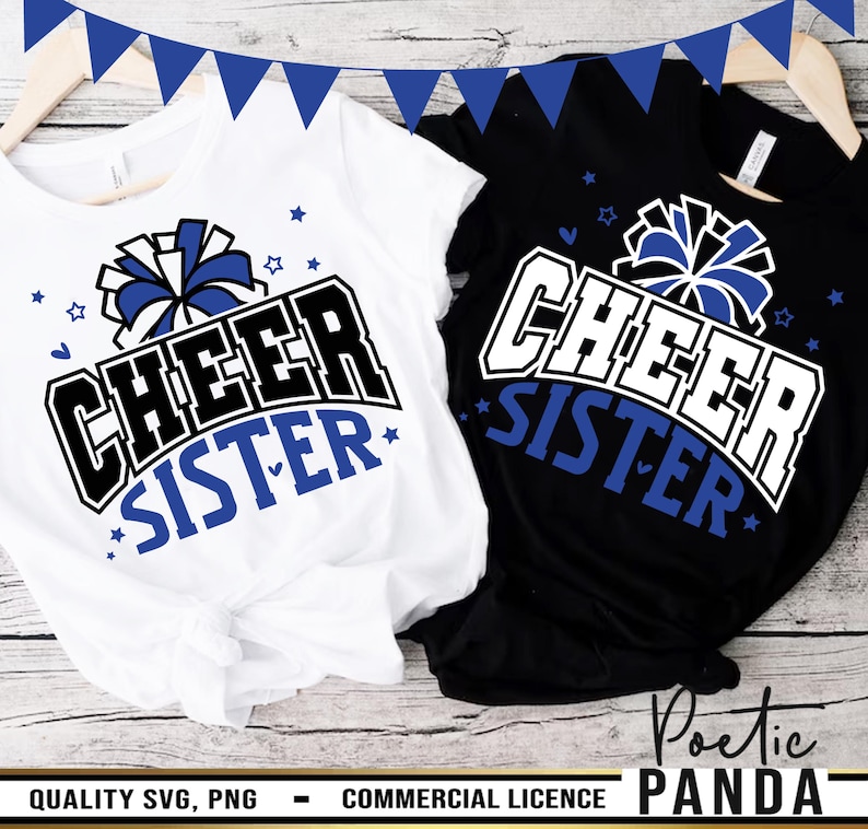 May include: Two white t-shirts with black and blue text that reads "Cheer Sister" and a blue and white pom-pom graphic. The shirts are on a wood surface.