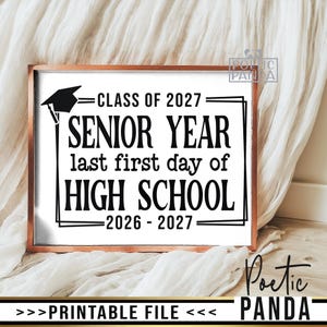 May include: A rectangular sign in a copper-colored frame featuring black text on a white background that reads: CLASS OF 2027, SENIOR YEAR, last first day of, HIGH SCHOOL, 2026 - 2027, with a black graduation cap icon in the upper left corner.