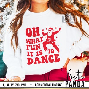 May include: White sweatshirt featuring the text "OH WHAT FUN IT IS TO DANCE" in red, with a dancing Santa Claus graphic. A festive Christmas-themed design.