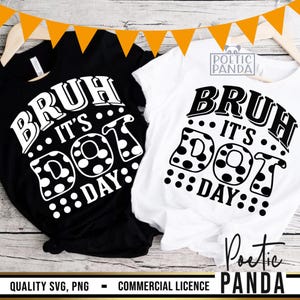 May include: Black and white t-shirts with the text "BRUH IT'S DOT DAY" in a playful font. The design includes polka dots and is displayed on a wooden surface with orange triangle decorations.