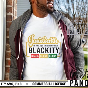 May include: A white t-shirt with a gold graphic that says "Juneteenth" and "I'm Black Every Day, But Today I'm Very Blackity" with three black squares that say "Black" in gold letters. The graphic is surrounded by a red, green, and yellow border.