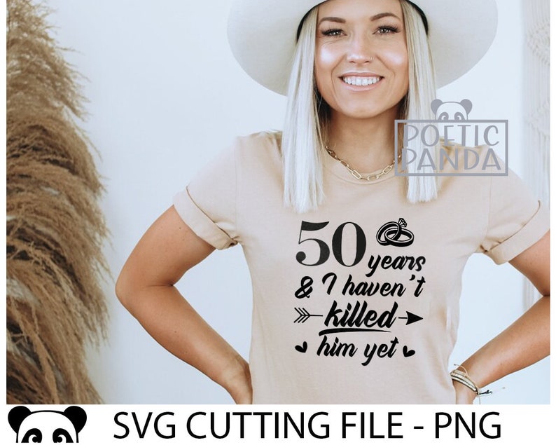 May include: A beige t-shirt with black text that reads "50 years & I haven't killed him yet" with a ring and arrow graphic.