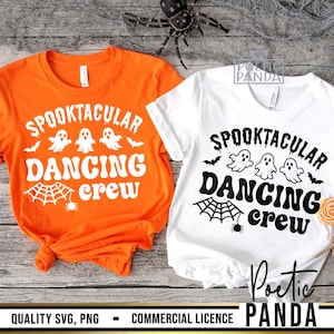 May include: Two Halloween-themed t-shirts, one orange and one white, with the text "Spooktacular Dancing Crew". The design includes ghosts, bats, and a spider web. The shirts are made of a soft material.