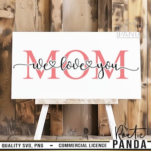 May include: A white sign with the words "MOM we love you" in pink and black lettering. The sign is on a wooden easel.